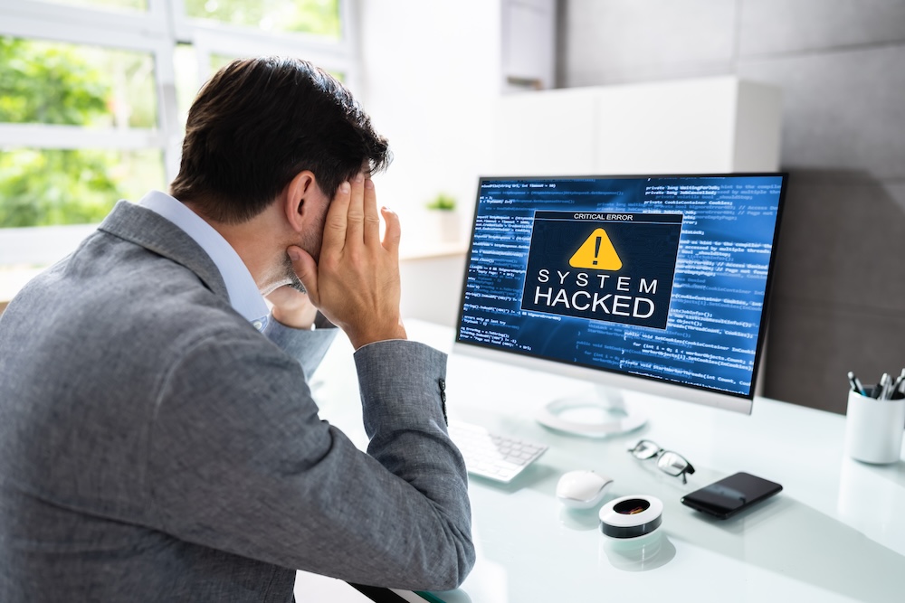 System hacked man looking at a computer